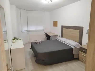 a bedroom with a bed and a desk in it at Montirón 113 - Fontiñas in Lugo