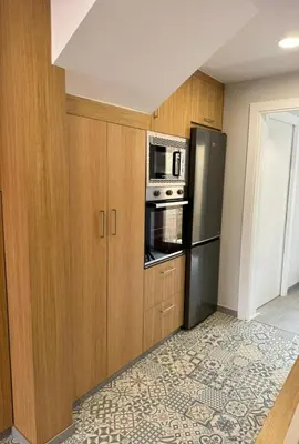 a kitchen with a refrigerator and a microwave at Casa a Xanela Azul in Celanova