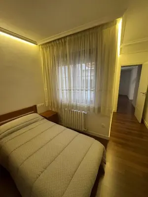 a bedroom with a large bed and a window at APARTAMENTO TURISTICO PLAZA DEL AYUNTAMIENTO in Ponferrada