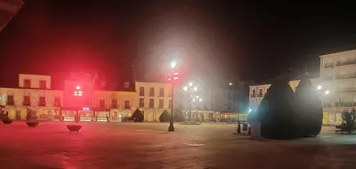 a city street at night with red lights at APARTAMENTO TURISTICO PLAZA DEL AYUNTAMIENTO in Ponferrada
