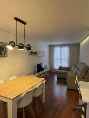 a living room with a table and a couch at APARTAMENTO TURISTICO PLAZA DEL AYUNTAMIENTO in Ponferrada