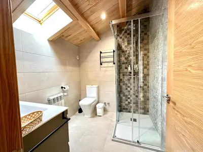 a bathroom with a glass shower and a toilet at Apartamentos Casa Courego in Vegadeo