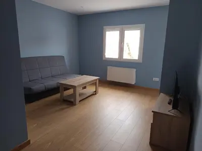 a living room with a couch and a table at Pensión Palomos in San Xoán de Río