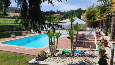 a swimming pool with palm trees in a yard at acasadeblanco in Teo