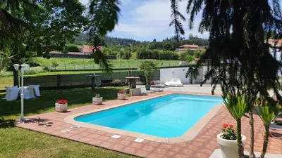 a swimming pool in the backyard of a house at acasadeblanco in Teo