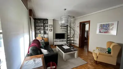 a living room with a couch and a table at Nice apartment overlooking Ponferrada Castle in Ponferrada