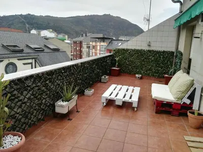 a balcony with a table and chairs on a building at Nice apartment overlooking Ponferrada Castle in Ponferrada