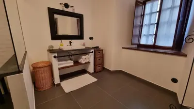 a bathroom with a sink and a mirror at Precioso apartamento con patio centro de Castropol in Castropol