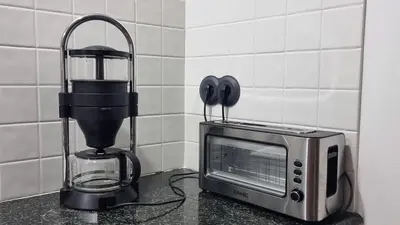 a kitchen counter with a coffee maker and a microwave at Precioso apartamento con patio centro de Castropol in Castropol
