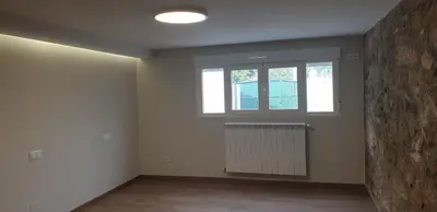an empty room with a window and a radiator at Villa Victoria in Teo