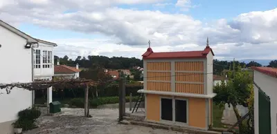 a building with a red roof on top of it at Villa Victoria in Teo