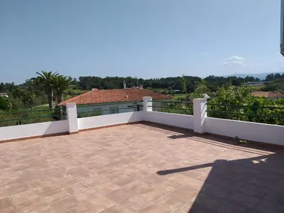 a balcony of a house with a roof at Villa Victoria in Teo