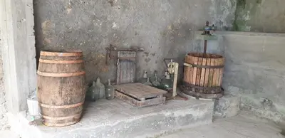 a room with bottles and a chair and barrels at Villa Victoria in Teo