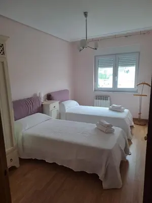 three beds in a room with white walls at Arca de Noé in Valle de Oro