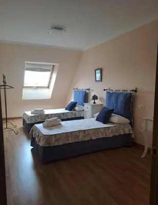 a bedroom with two beds and a window at Arca de Noé in Valle de Oro