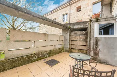 a patio with a table and chairs and a building at Casa Doña Blanca, Ourense in San Clodio
