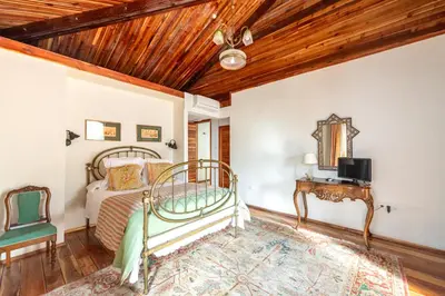a bedroom with a bed and a wooden ceiling at Casa Doña Blanca, Ourense in San Clodio