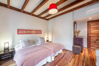 a bedroom with a bed and a wooden floor at Casa Doña Blanca, Ourense in San Clodio