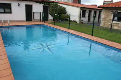 a swimming pool with a starfish in the water at A Lúa do Camiño in Melide