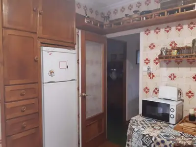 a kitchen with a white refrigerator and a microwave at Casa Vallejo en Crecente in Crecíente