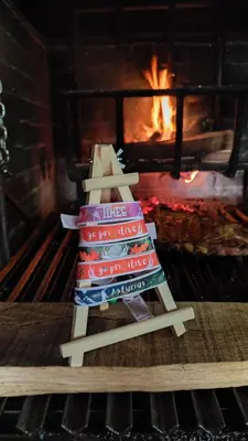 a stack of blankets in front of a fireplace at Pension Parrilla Casa Vicente in Tineo