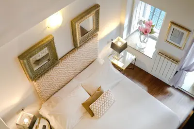 an overhead view of a room with a bed and a staircase at Inicia Casas Reales in Santiago de Compostela