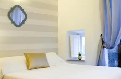 a bedroom with a white bed and a window at Inicia Casas Reales in Santiago de Compostela