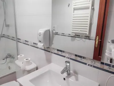 a bathroom with a sink and a mirror at Inicia Casas Reales in Santiago de Compostela