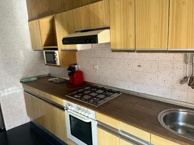 a small kitchen with a stove and a sink at Universidad Piso Artur II in Ourense
