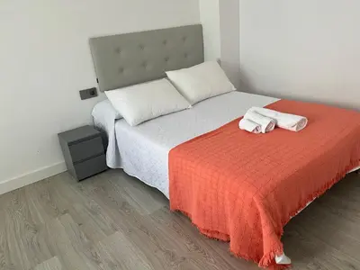 a bedroom with a bed with two towels on it at Universidad Piso Artur II in Ourense