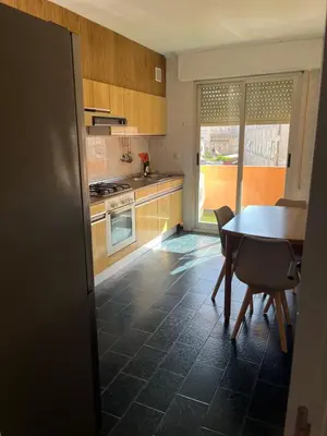 a kitchen with a table and a table and chairs at Universidad Piso Artur II in Ourense