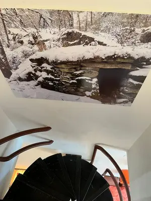 two pictures of a fireplace with snow on it at Dupléx en Estación de Manzaneda in Prada