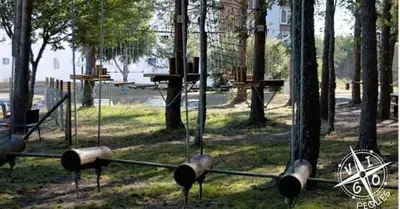 a park with a swing set in the trees at Dupléx en Estación de Manzaneda in Prada