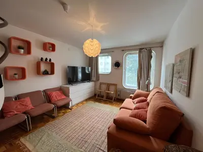 a living room with a couch and a tv at Dupléx en Estación de Manzaneda in Prada
