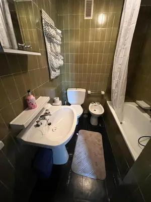 a bathroom with a sink and a toilet and a tub at Dupléx en Estación de Manzaneda in Prada