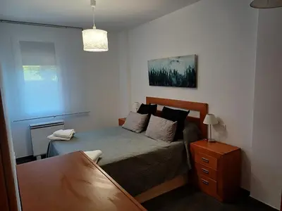a small bedroom with a bed and a table at Xove Home Mar de Lugo in Jove