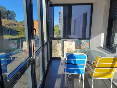 a balcony with a table and chairs and a window at Xove Home Mar de Lugo in Jove