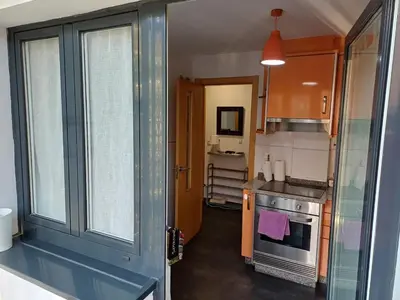 a small kitchen with a stove and a window at Xove Home Mar de Lugo in Jove