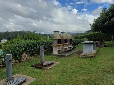 a group of vases sitting in the grass at Xove Home Mar de Lugo in Jove