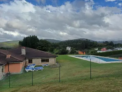 a house with a swimming pool in a field at Xove Home Mar de Lugo in Jove