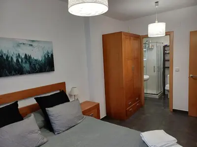 a bedroom with a bed and a bathroom at Xove Home Mar de Lugo in Jove