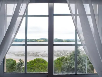 a window with a view of the ocean at Apartamento O Cobo Miño in Miño