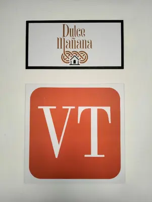 two signs for the duke of mauritius and a sign for v at Dulce Mañana in Portomarin