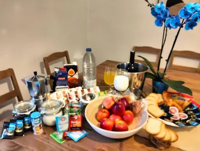 a table topped with a bowl of fruit and other food at Dulce Mañana in Portomarin