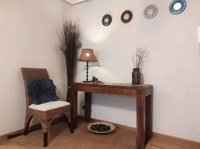 a room with a desk and a chair and clocks at Con vistas al puente del Milenio y plaza de garaje in Ourense
