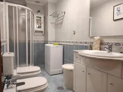 a bathroom with a sink and a toilet and a shower at Con vistas al puente del Milenio y plaza de garaje in Ourense