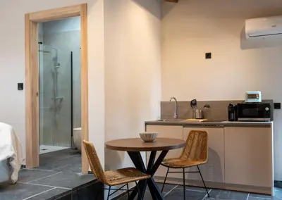a kitchen with a table and chairs and a sink at A Rectoral de Seadur in Seadur