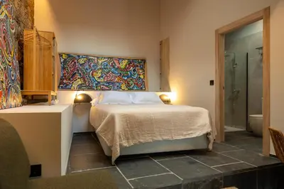 a bedroom with a bed and a painting on the wall at A Rectoral de Seadur in Seadur