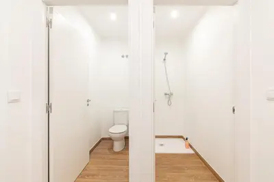 a white bathroom with a toilet in a room at Casa de montaña - A Palleira do Curralón in Pradoalvar