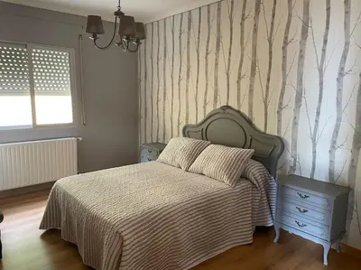 a bedroom with a bed and a dresser and a window at Casa Daló II in Folgoso